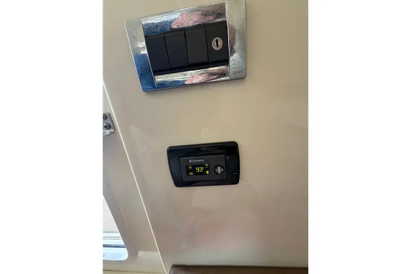 Slide: The Image of Control panel and thermostat on 2017 Chris-Craft Catalina 34 boat interior. - 28