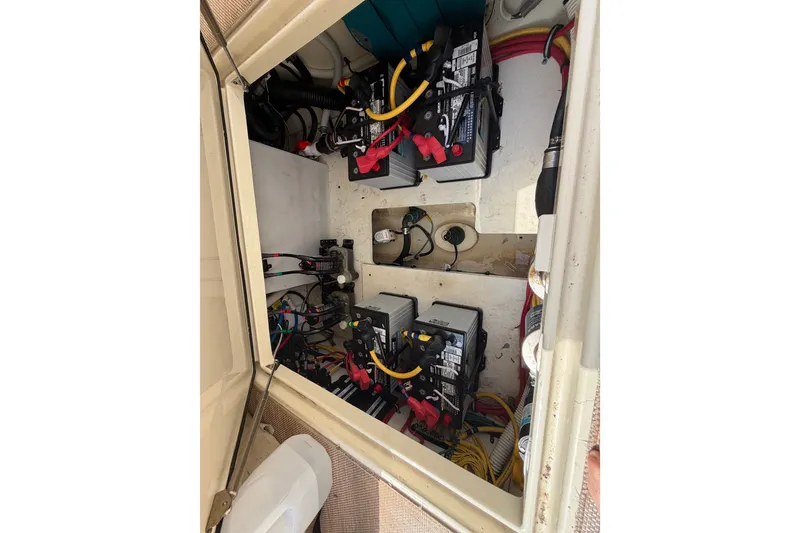 Slide: The Image of Engine compartment of a 2017 Chris-Craft Catalina 34, showcasing batteries and wiring. - 18