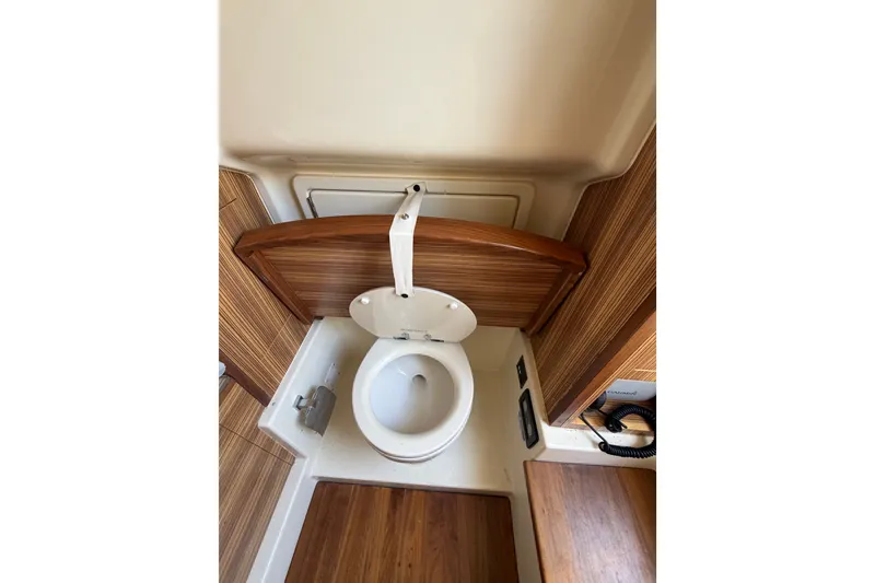 Slide: The Image of 2017 Chris-Craft Catalina 34 boat interior with wooden finish and toilet. - 23