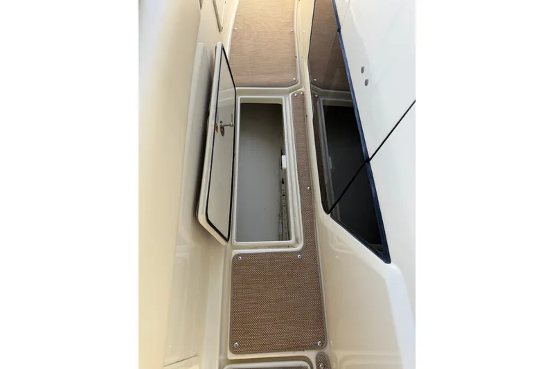 Slide: The Image of 2017 Chris-Craft Catalina 34 storage compartment with open hatch, showcasing interior space. - 22