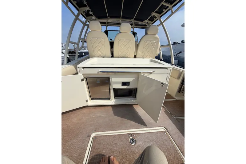 Slide: The Image of 2017 Chris-Craft Catalina 34 interior with open storage and seating area. - 15