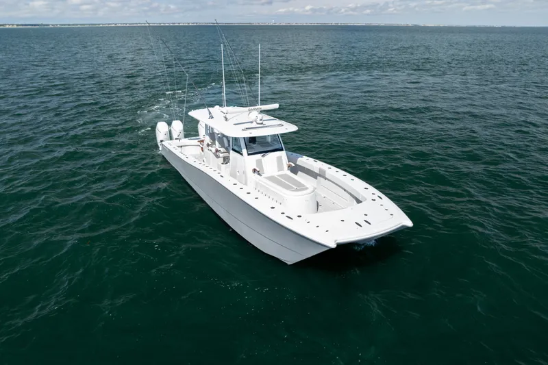 Slide: The Image of 2024 Freeman 43 boat cruising on open water under a partly cloudy sky. - 36
