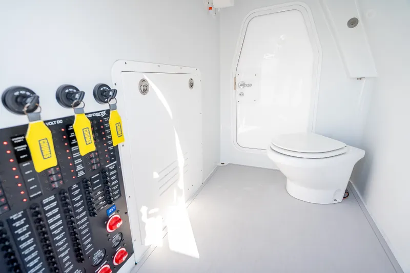 Slide: The Image of Interior of 2024 Freeman 43 boat featuring control panel and marine toilet. - 24