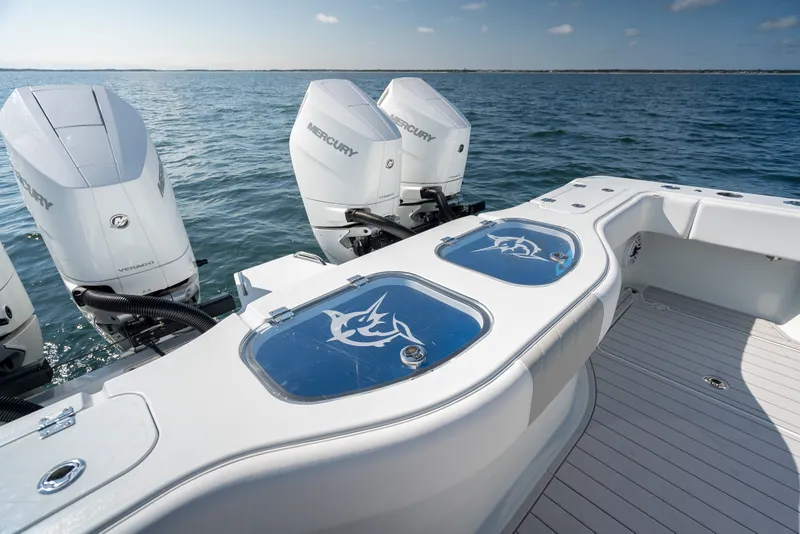Slide: The Image of 2024 Freeman 43 boat with Mercury engines, featuring sleek deck design and ocean backdrop. - 28