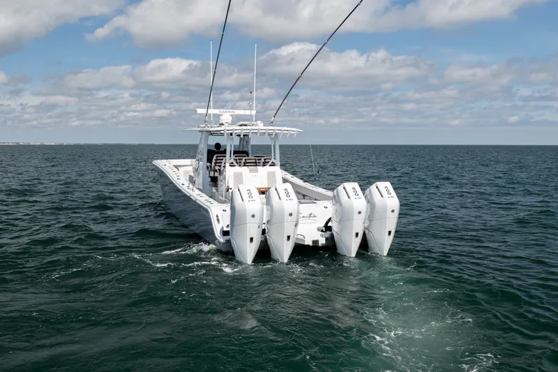 Slide: The Image of 2024 Freeman 43 boat with quad engines cruising on open water under a cloudy sky. - 31
