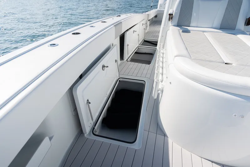 Slide: The Image of 2024 Freeman 43 boat deck with open storage compartments and cushioned seating. - 18