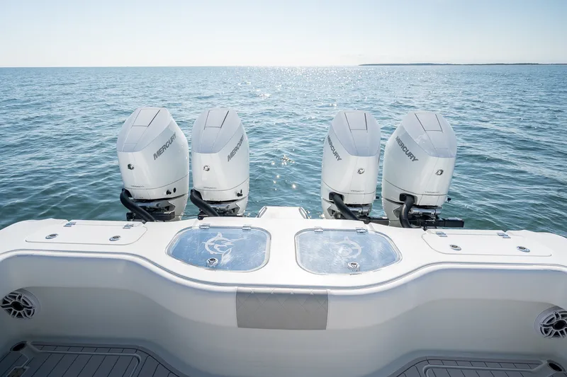 Slide: The Image of Four Mercury outboard engines on a 2024 Freeman 43 boat, cruising on open water. - 23