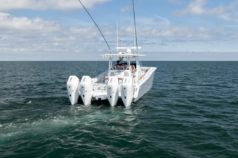 Slide: The Image of 2024 Freeman 43 boat with four engines cruising on open sea under blue sky. - 32