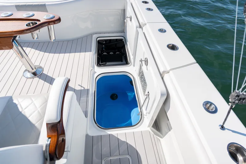Slide: The Image of 2024 Freeman 43 boat deck with open storage compartments and fishing rod holders. - 20