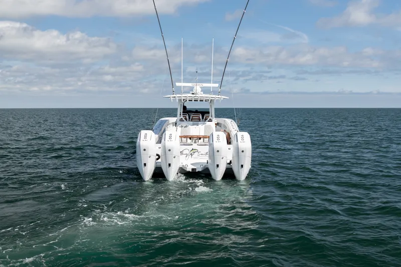 Slide: The Image of 2024 Freeman 43 boat with multiple engines cruising on open sea under a partly cloudy sky. - 30