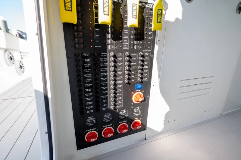 Slide: The Image of Electrical control panel on a 2024 Freeman 43 boat, featuring switches and circuit breakers. - 25