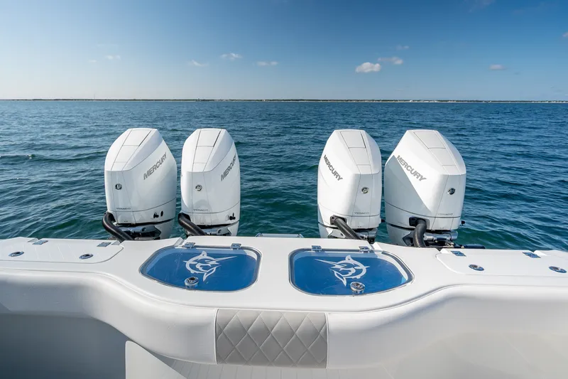 Slide: The Image of 2024 Freeman 43 boat with four Mercury outboard engines on open water. - 27