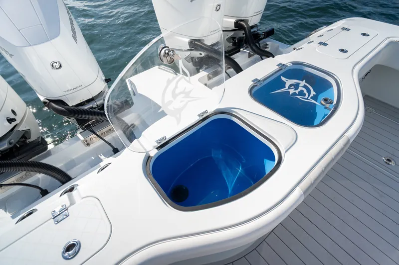 Slide: The Image of 2024 Freeman 43 boat with dual livewells and powerful outboard engines on the water. - 29