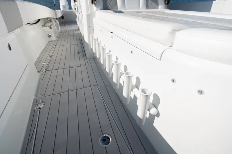 Slide: The Image of 2024 Freeman 43 boat deck with rod holders and cushioned seating. - 17
