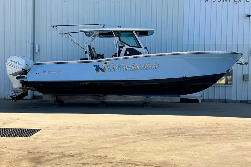 Slide: The Image of 2021 Blackfin 332 CC boat on display, featuring sleek design and powerful engines. - 1