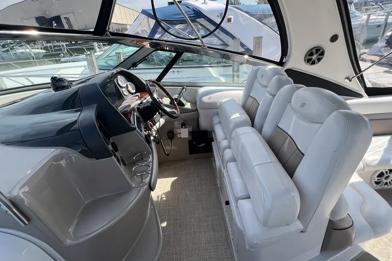 Slide: The Image of Interior of 2006 Four Winns 348 Vista boat with white seating and modern dashboard. - 4