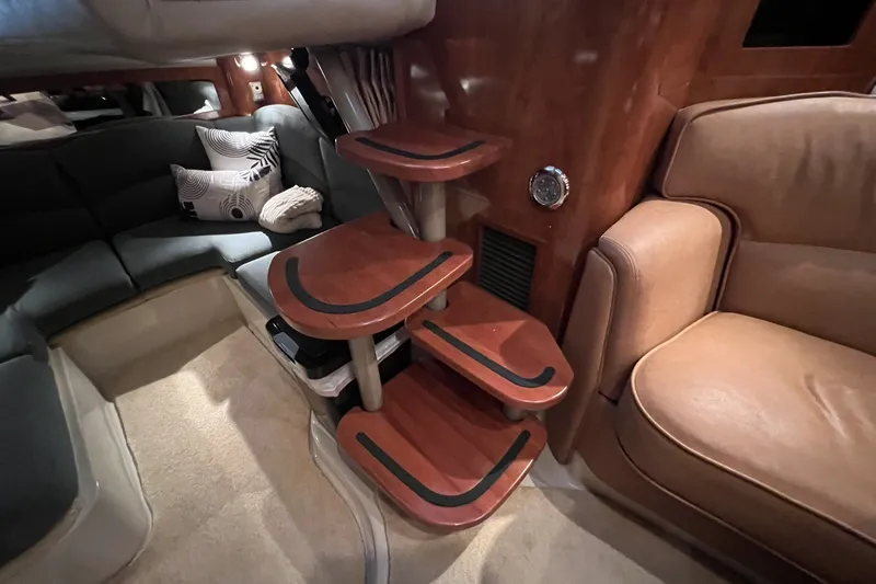 Slide: The Image of Interior of 2006 Four Winns 348 Vista yacht with wooden steps and plush seating. - 6