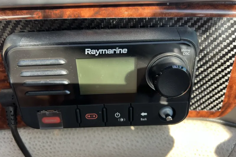 Slide: The Image of Raymarine marine radio on 2006 Four Winns 348 Vista dashboard with carbon fiber trim. - 14