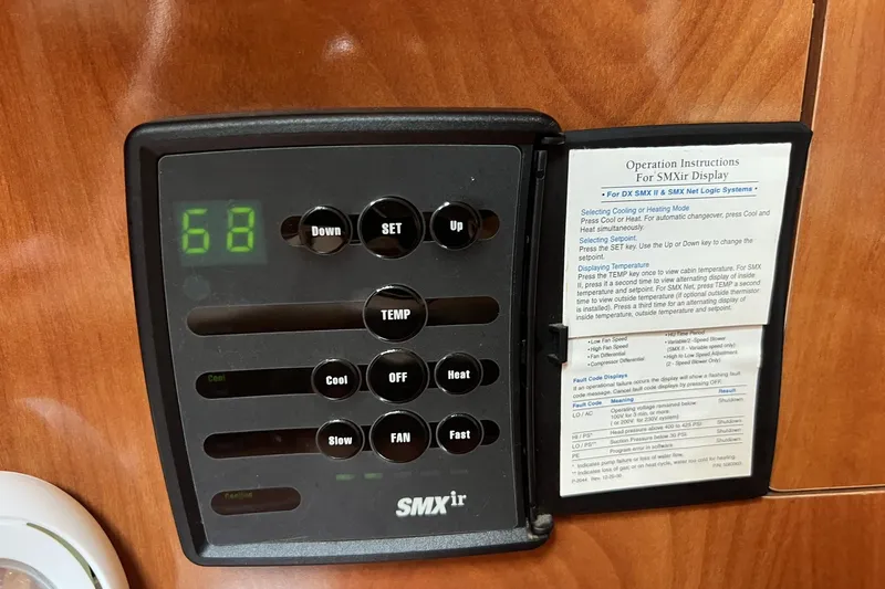 Slide: The Image of SMXir climate control panel in 2006 Four Winns 348 Vista boat, displaying temperature settings. - 10