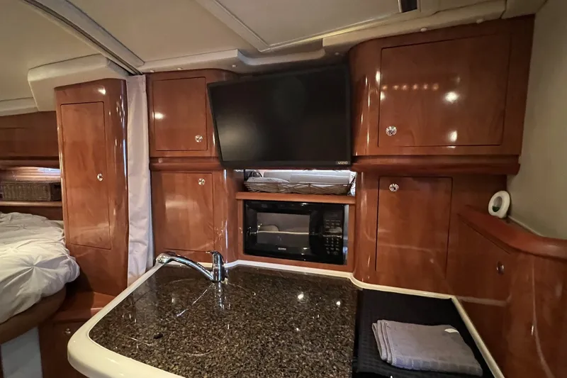 Slide: The Image of Luxurious interior of 2006 Four Winns 348 Vista yacht with kitchenette and entertainment center. - 29