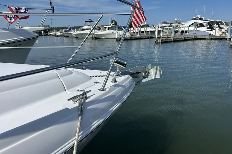 Slide: The Image of 2006 Four Winns 348 Vista yacht docked in a marina with American flag. - 24