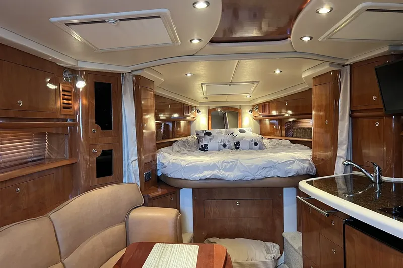 The Image of Luxurious interior of 2006 Four Winns 348 Vista yacht with cozy bed and elegant wood finishes. - 0