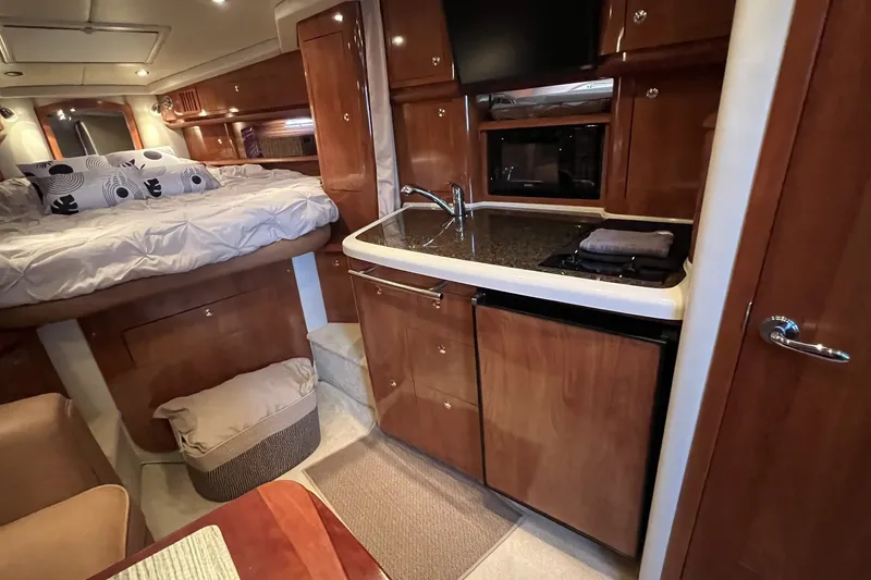 Slide: The Image of Interior of 2006 Four Winns 348 Vista yacht with kitchenette and cozy sleeping area. - 1