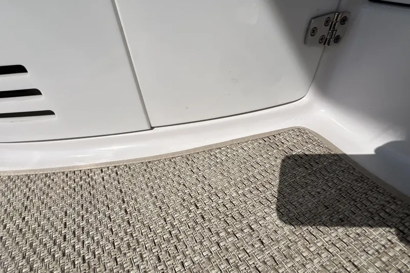 Slide: The Image of Interior detail of 2006 Four Winns 348 Vista boat, featuring textured flooring and white paneling. - 42