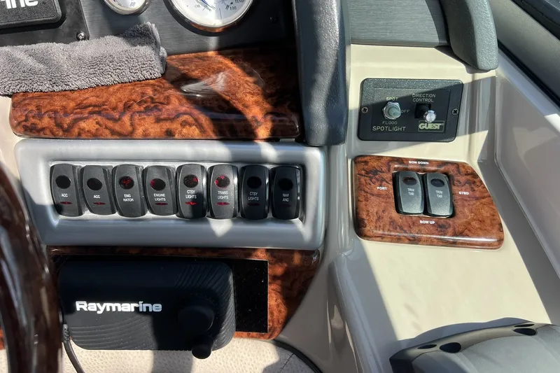 Slide: The Image of Control panel of a 2006 Four Winns 348 Vista boat with switches and gauges. - 13