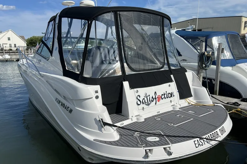 Slide: The Image of 2006 Four Winns 348 Vista boat docked at marina, featuring "Satisfaction" nameplate. - 22