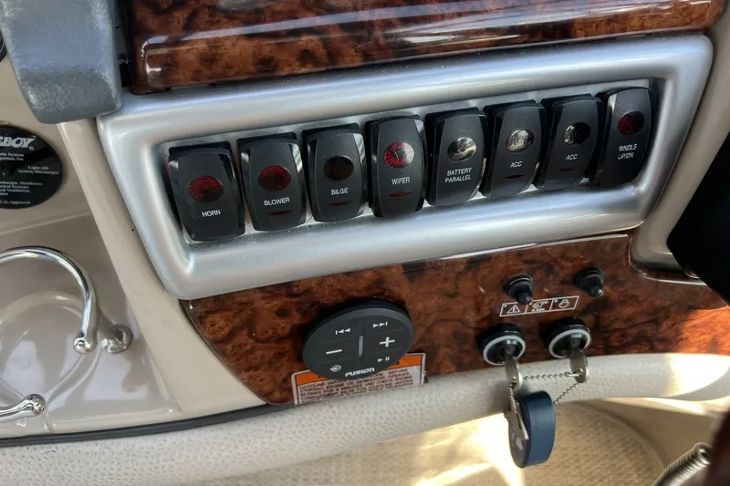 Slide: The Image of Control panel of a 2006 Four Winns 348 Vista boat with labeled switches. - 15