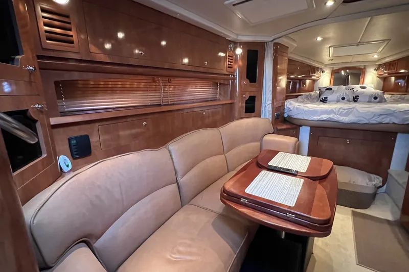 Slide: The Image of Luxurious 2006 Four Winns 348 Vista yacht interior with plush seating and elegant wood finishes. - 25