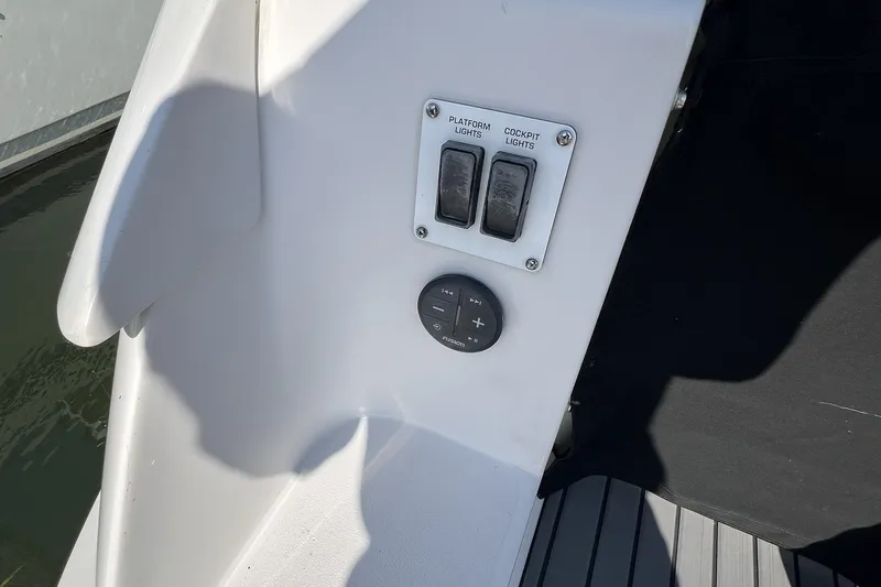 Slide: The Image of Control panel on 2006 Four Winns 348 Vista boat, featuring light switches and audio controls. - 21