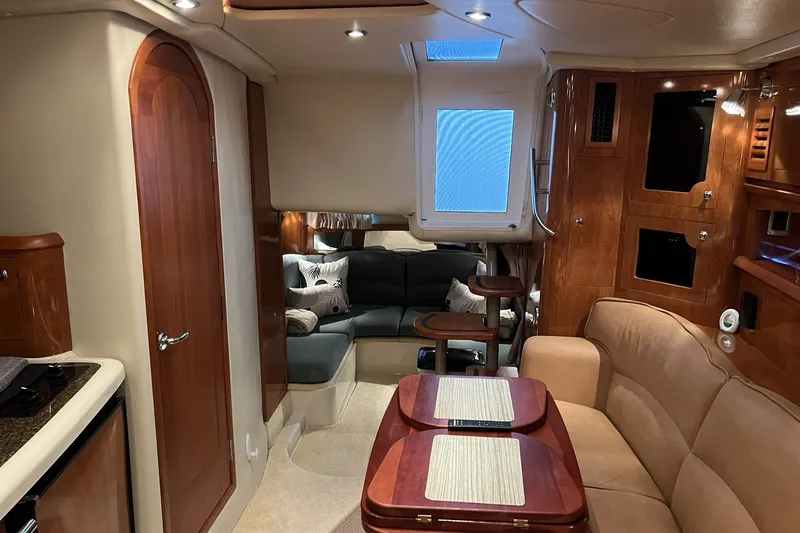 Slide: The Image of Interior of 2006 Four Winns 348 Vista yacht with cozy seating and wooden cabinetry. - 2
