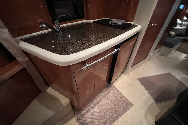 Slide: The Image of 2006 Four Winns 348 Vista yacht interior with sleek kitchen countertop and modern cabinetry. - 5