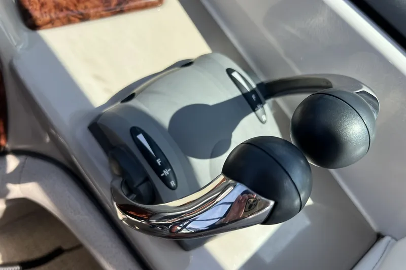 Slide: The Image of Throttle controls of a 2006 Four Winns 348 Vista boat cockpit. - 18
