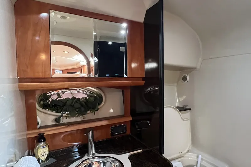 Slide: The Image of 2006 Four Winns 348 Vista yacht interior with wooden cabinetry and sink. - 7