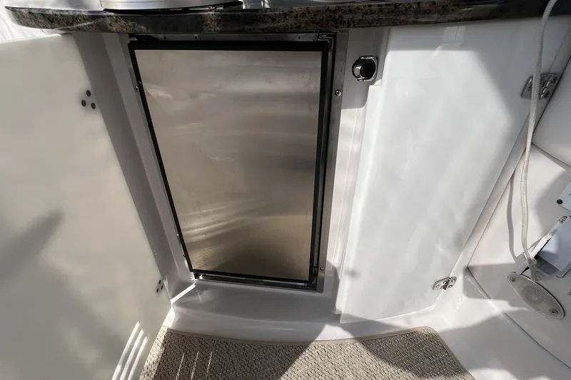 Slide: The Image of 2006 Four Winns 348 Vista boat interior with stainless steel fridge and white cabinetry. - 20