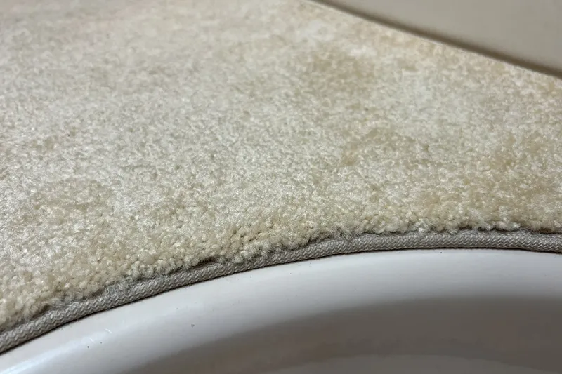 Slide: The Image of Close-up of beige carpet edge on a 2006 Four Winns 348 Vista boat. - 11
