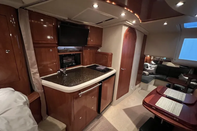 Slide: The Image of Luxurious 2006 Four Winns 348 Vista yacht interior with kitchenette and seating area. - 27