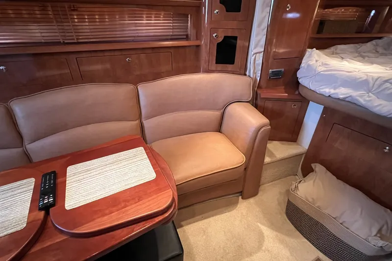 Slide: The Image of Interior of 2006 Four Winns 348 Vista yacht with leather seating and wooden table. - 26