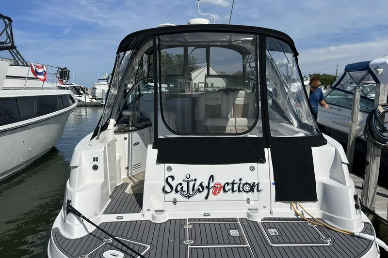 Slide: The Image of 2006 Four Winns 348 Vista boat docked, featuring "Satisfaction" name on the stern. - 45