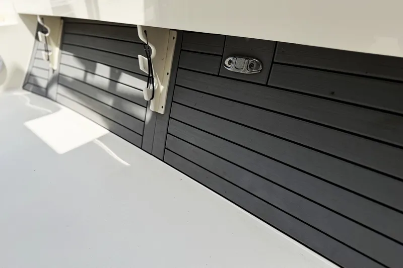 Slide: The Image of 2022 Pathfinder 2600 HPS boat interior with sleek black paneling and modern design elements. - 11