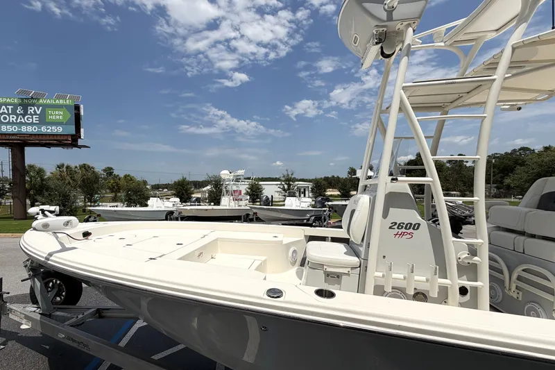 Slide: The Image of 2022 Pathfinder 2600 HPS boat on trailer under clear sky. - 7