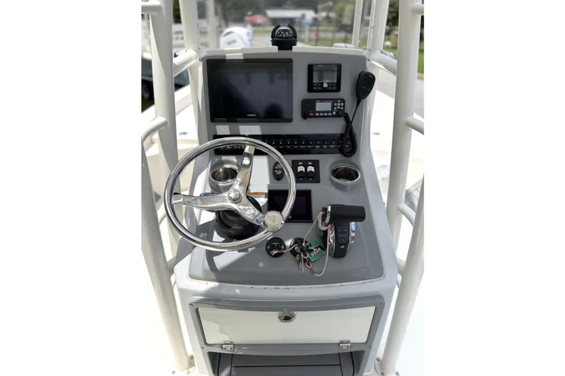Slide: The Image of 2022 Pathfinder 2600 HPS boat console with steering wheel, navigation screens, and controls. - 19