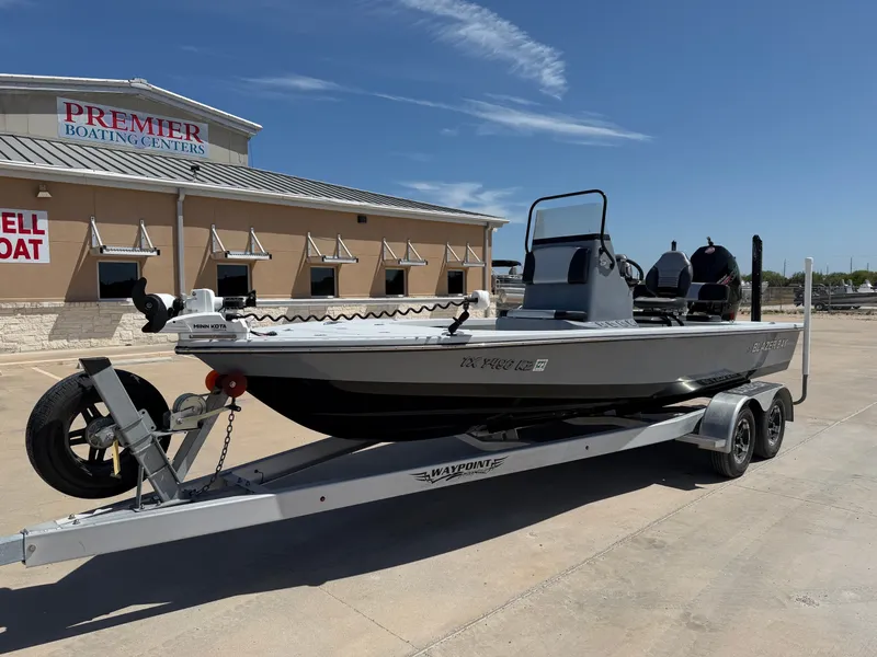 Slide: The Image of A 2023 Blazer Bay 2220 GTS on a trailer in front of a boating center. - 3