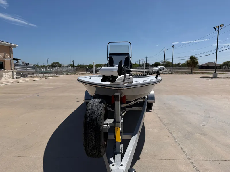 Slide: The Image of A 2023 Blazer Bay 2220 GTS boat on a trailer in an open area. - 5