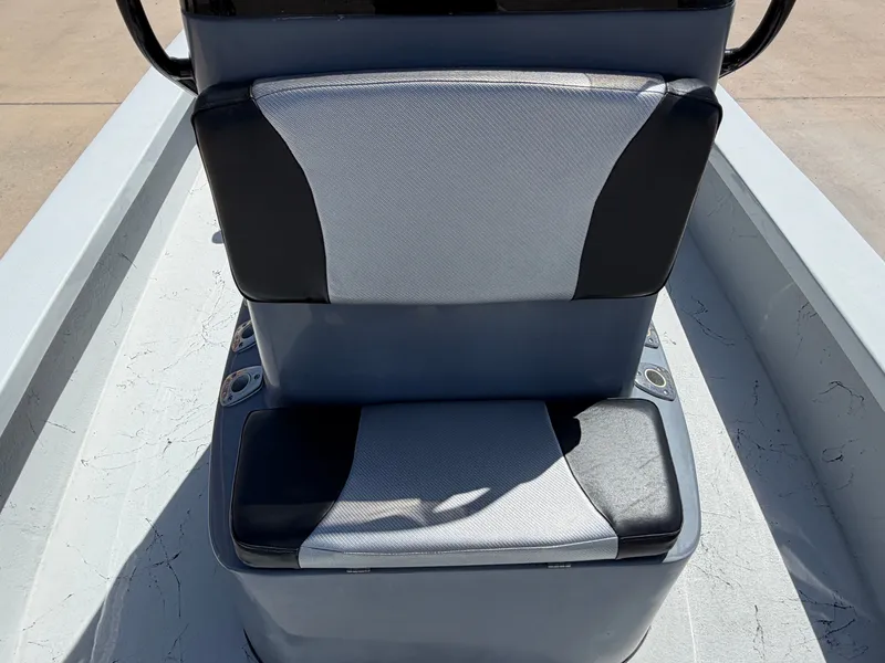 Slide: The Image of A gray and black seat on a boat with cup holders on the sides. - 17