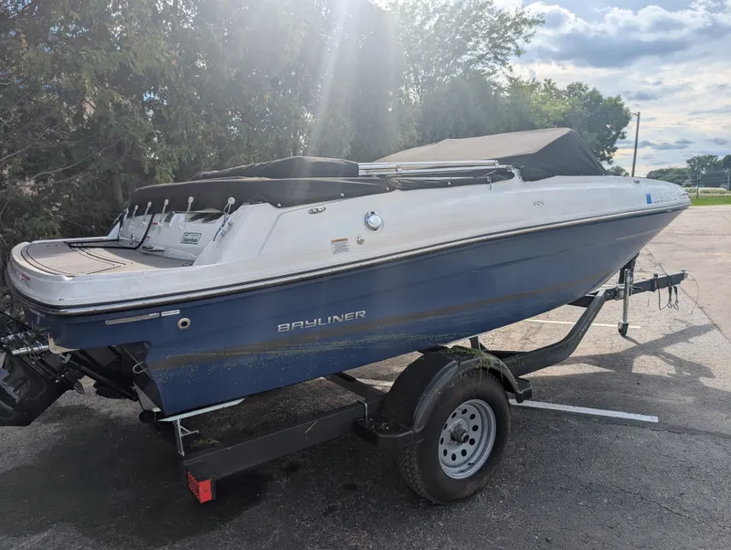 Slide: The Image of A 2023 Bayliner VR4 Bowrider on a trailer, featuring a blue hull and black cover. - 6