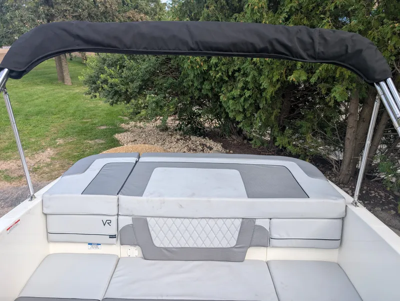 Slide: The Image of The image shows the rear of a Bayliner VR4 Bowrider with gray cushions and a black bimini top. - 8